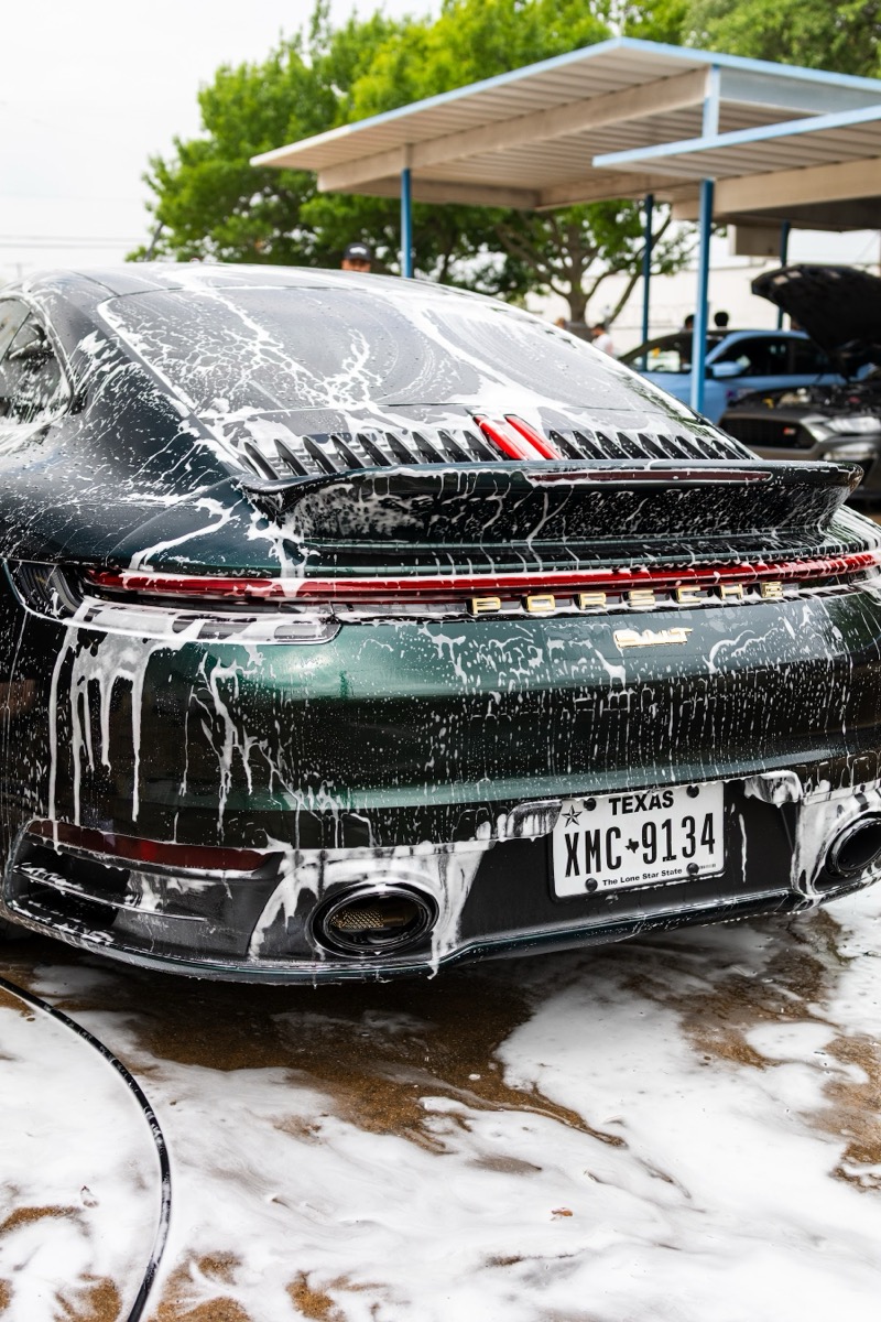 Dust-covered black SUV awaiting detail — the 'before' state