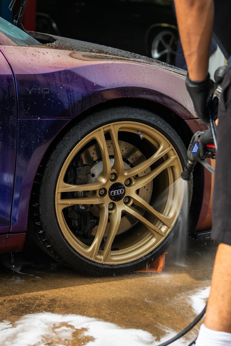 Sunlight catching brake caliper through cleaned bronze wheel